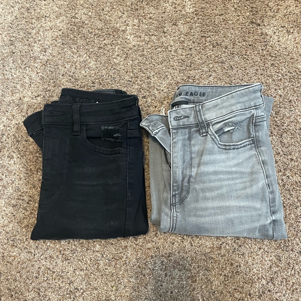 Two pairs of American Eagle jeans.